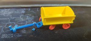 A playmobil cart that has suffered at the hands of children.